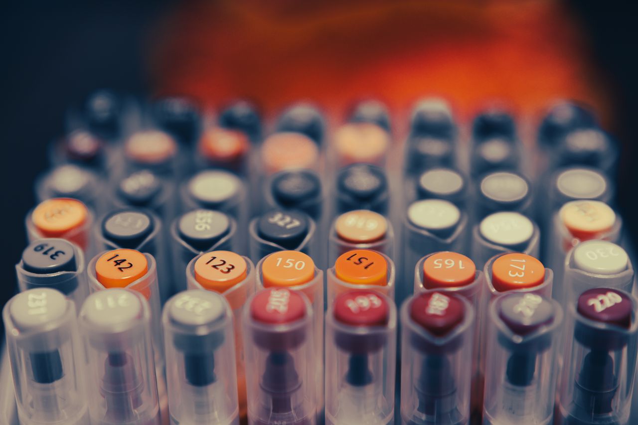Close-up view of colorful art markers arranged in rows, showing vibrant variety.